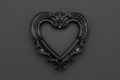 A black ornate heart-shaped decorative frame or picture frame with baroque-style scrollwork, centered on a dark gray background.