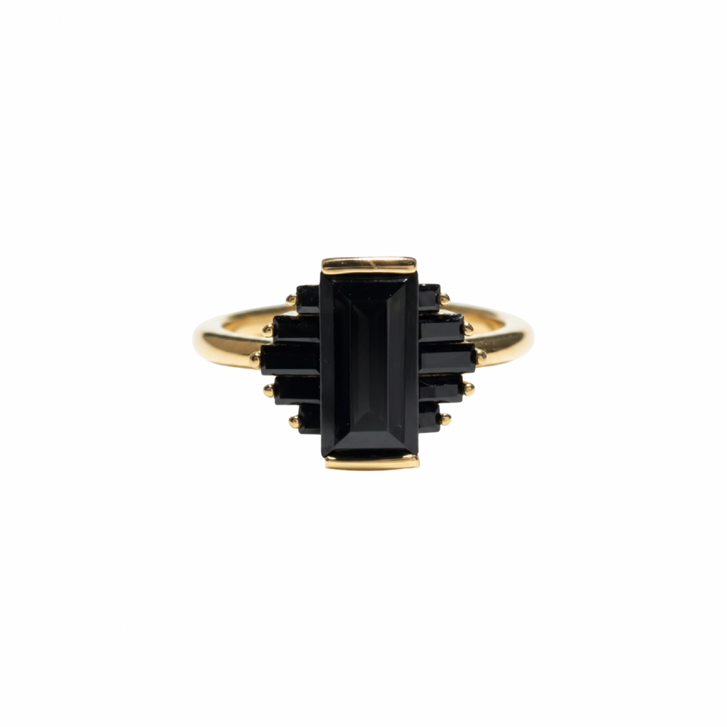 A gold ring featuring a central rectangular black gemstone surrounded by smaller stacked black rectangular stones, set on a plain white background, kookikent.