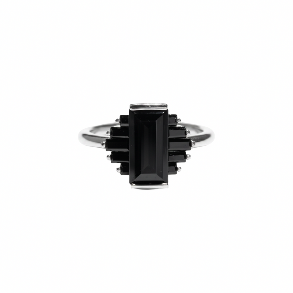 A silver ring featuring a central rectangular black gemstone surrounded by smaller black rectangular stones, set on a plain white background, kookikent.