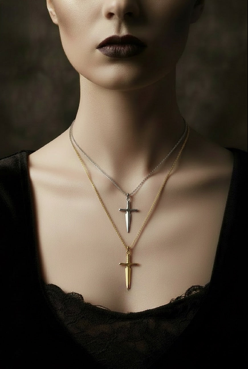 Close-up of a woman wearing two cross necklaces with a dark background