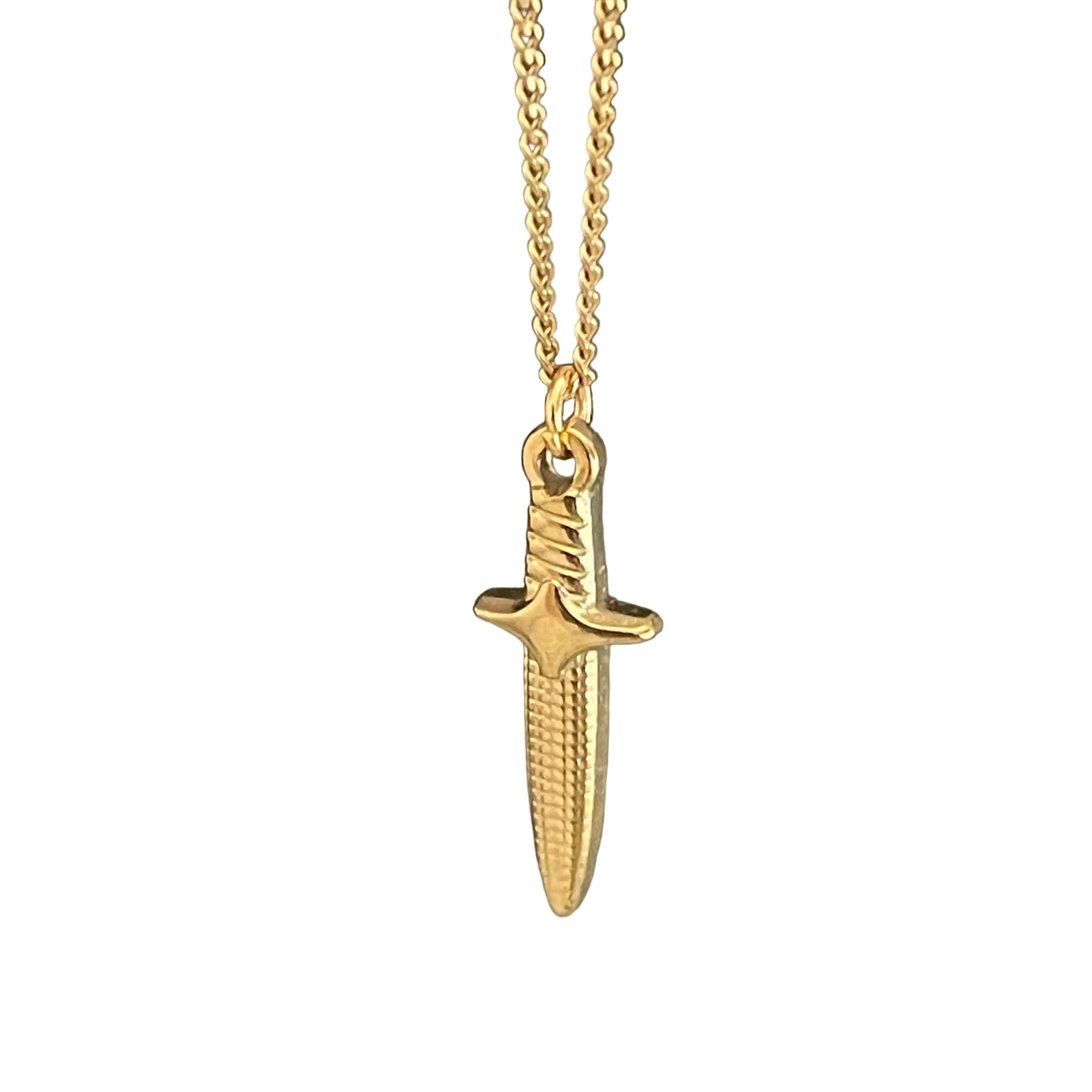 Gold dagger-shaped pendant on a chain against a white background