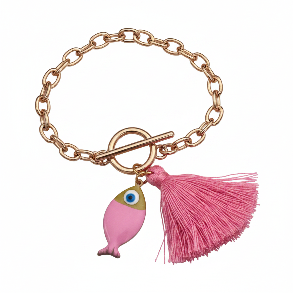 Gold chunky bracelet with a pink fish and pink tassel on a white background. 