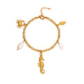 Gold bracelet with seahorse, crab, seashell, shell heart and pearl charm on a white background