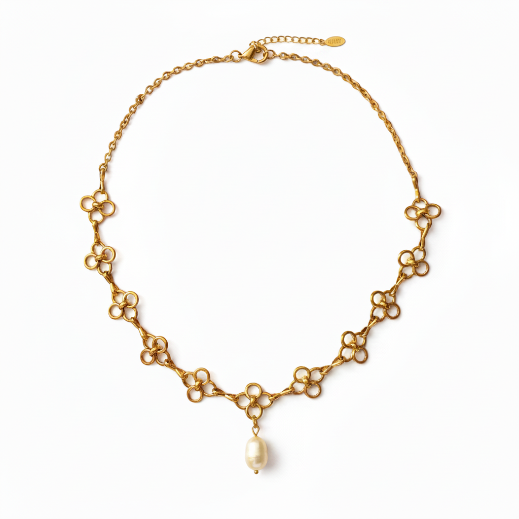 A gold-tone chain necklace featuring a series of small flower-like links with a single white pearl pendant hanging at the center, shown on a plain white background.
