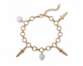Gold bracelet with heart and dagger charms on a white background