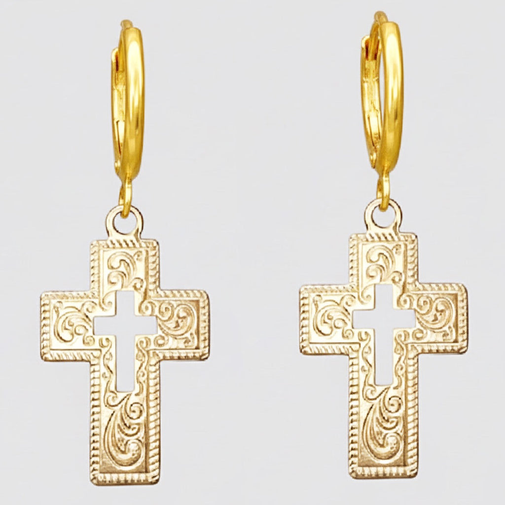Gold cross earrings on a light grey background.