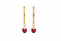 A pair of gold hoop earrings with faceted red gemstone drops, shown against a plain white background.