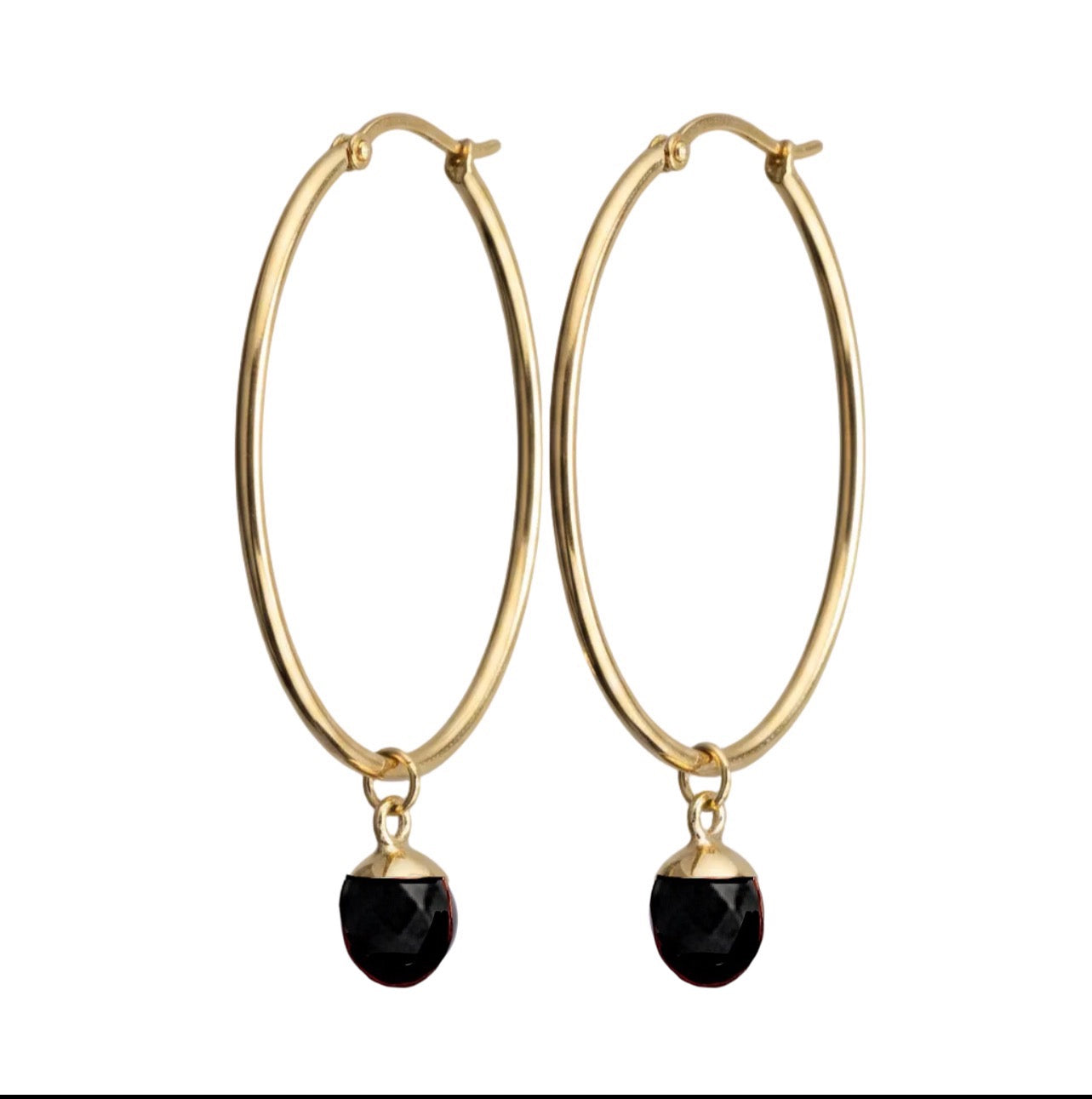 Gold hoop earrings with black gemstones on a white background