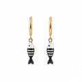 Gold fish-shaped earrings with black and white stripes on a white background