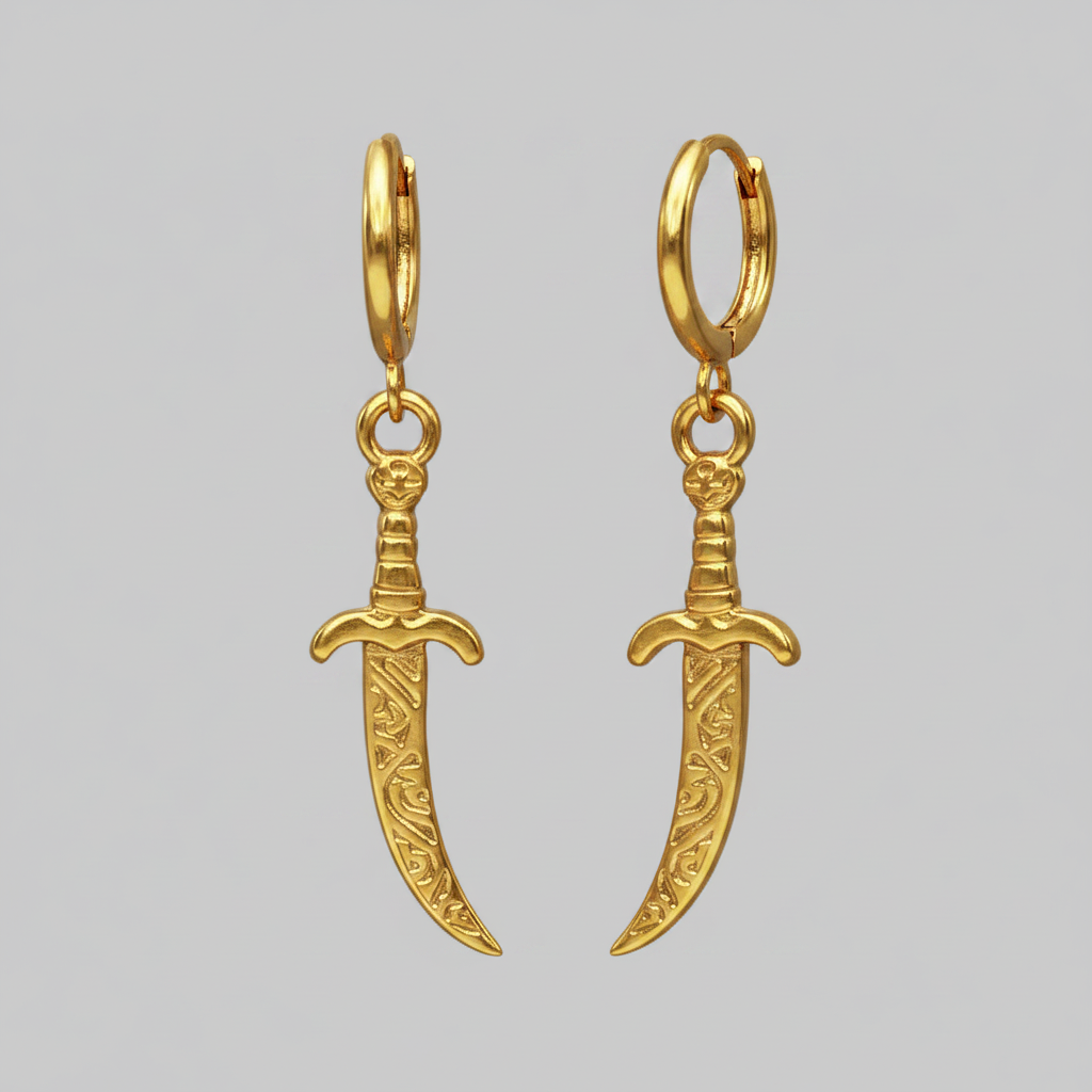 Gold sword-shaped earrings on a gray background