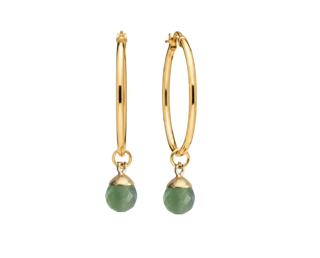 A pair of gold hoop earrings with faceted green bead drops, shown against a plain white background.