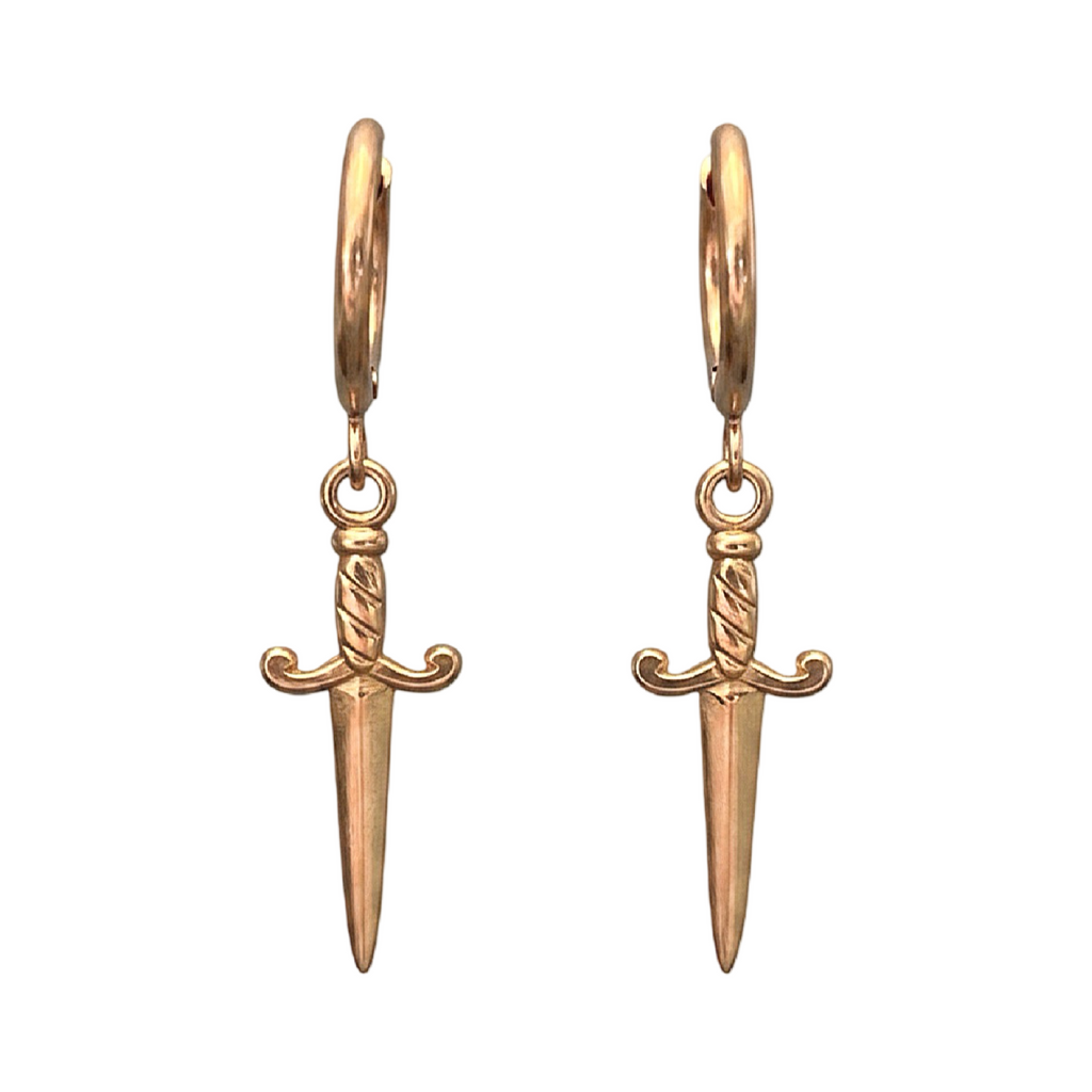 Gold sword-shaped earrings on a white background