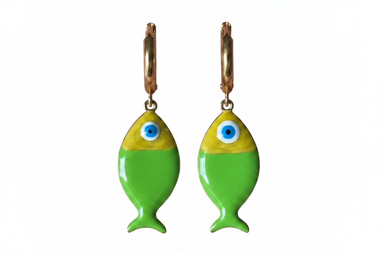 Green fish-shaped earrings with blue eyes on a white background