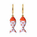 Gold fish-shaped earrings with orange and white design on a white background