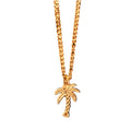 Gold necklace with a palm tree pendant on a white background