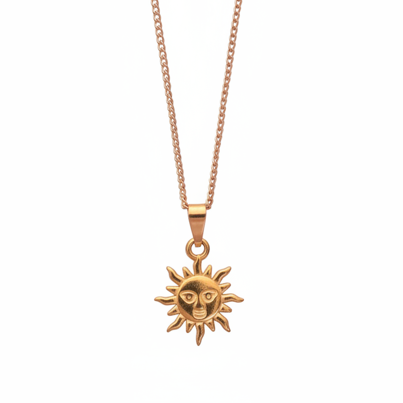 Gold sun-shaped pendant on a chain against a white background