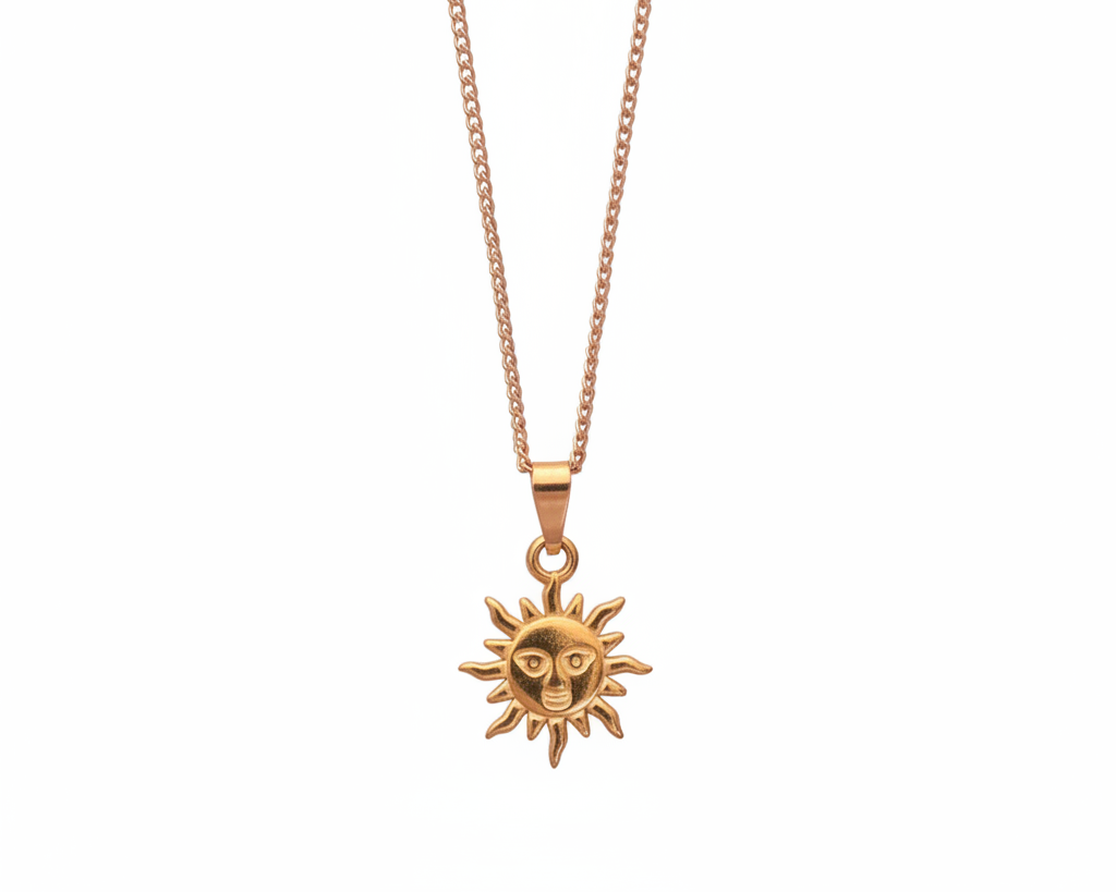 Gold sun-shaped pendant necklace on a white background