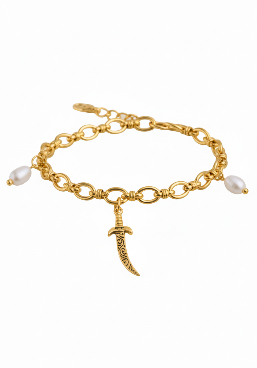 A gold chain bracelet featuring a central crescent moon pendant with engraved details, accented by two white pearl beads at the ends, shown on a plain white background.