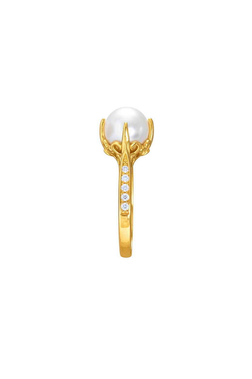 A gold ring featuring a large, round pearl in a claw setting, with a channel-set row of small clear stones along the band, shown against a plain white background.