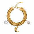 Gold bracelet with moon and heart charms on a white background