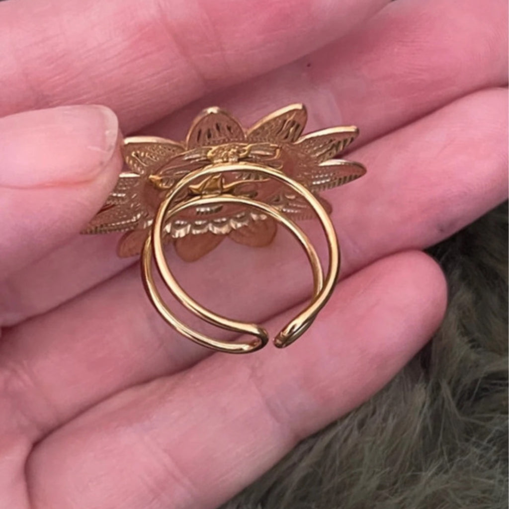 Gold sun ring held in a hand