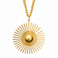 A gold sunburst pendant necklace with a central dome and radiating spikes, suspended from a gold chain against a plain white background.