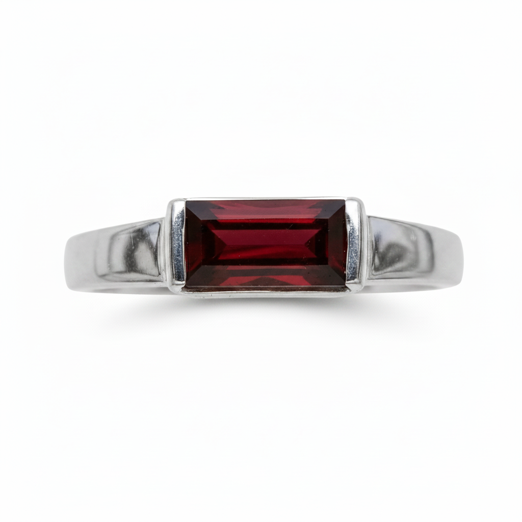 A silver ring with a rectangular red gemstone, against a white background.