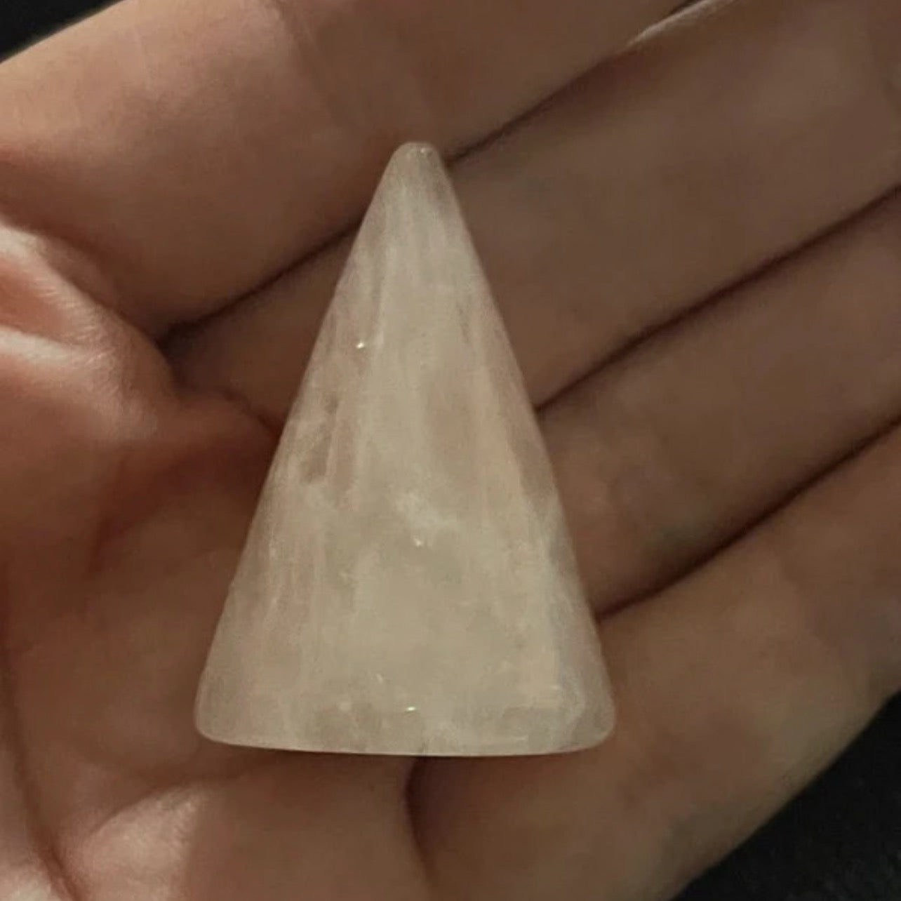 Conical stone held in a hand
