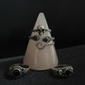 Clear crystal cone with rings on a dark textured surface