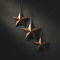 Rustic star-shaped ornaments on a green textured surface