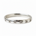 A silver band ring featuring a row of small, starburst-shaped diamond motifs set along the front, shown against a plain white background.