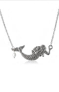 Silver mermaid necklace with a detailed mermaid figure on a chain, featuring a small dangling white pearl, shown against a plain white background.