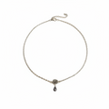 A delicate silver chain necklace featuring a small silver rose charm and a dark teardrop pendant, displayed on a clean white background.