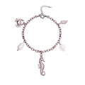 Bracelet with seahorse, shell, crab, shell heart and pearl charms on a white background