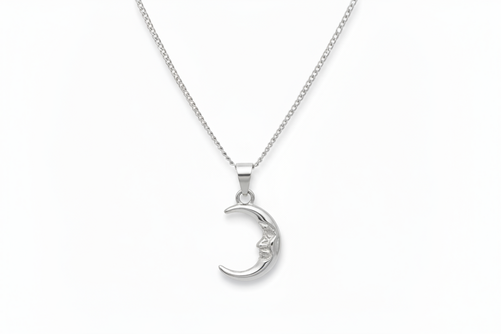 Silver moon-shaped pendant on a chain against a white background