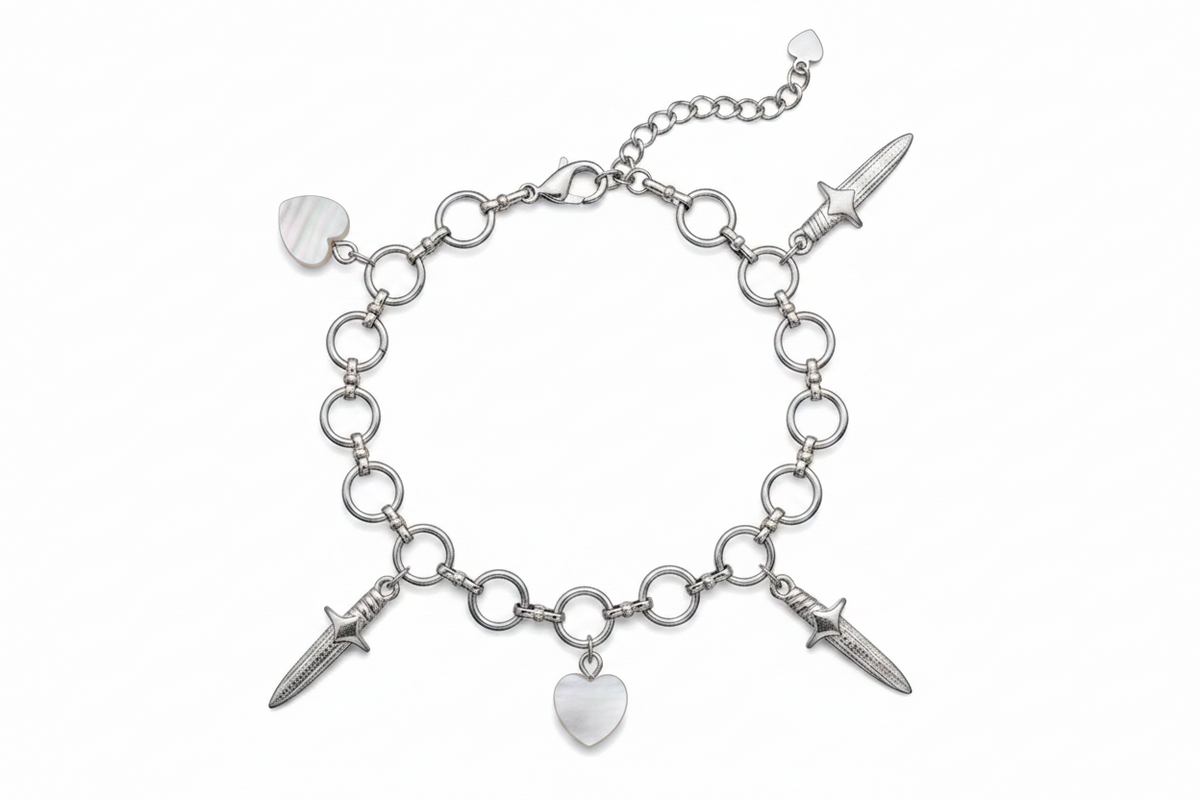 Silver bracelet with dagger and heart charms on a white background