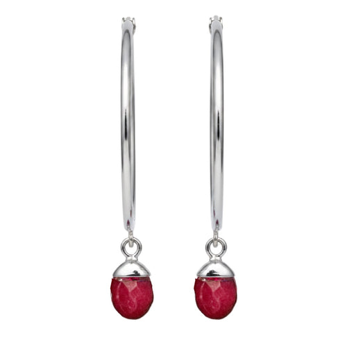 Silver earrings with red gemstones on a white background
