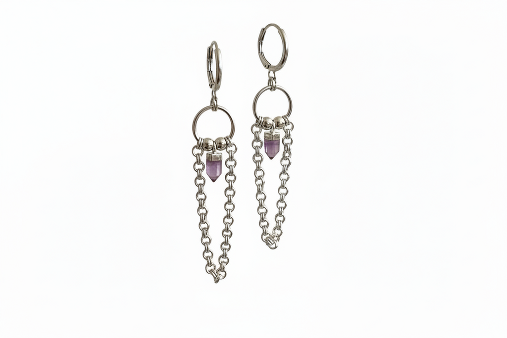 Silver earrings with chain and purple gemstone drops on a white background
