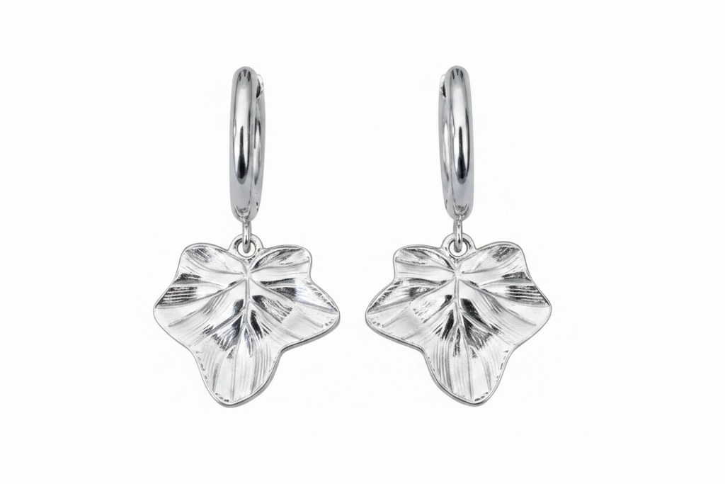 Pair of silver leaf-shaped earrings on a white background