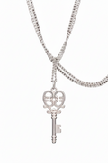 Silver key-shaped pendant on a chain against a white background