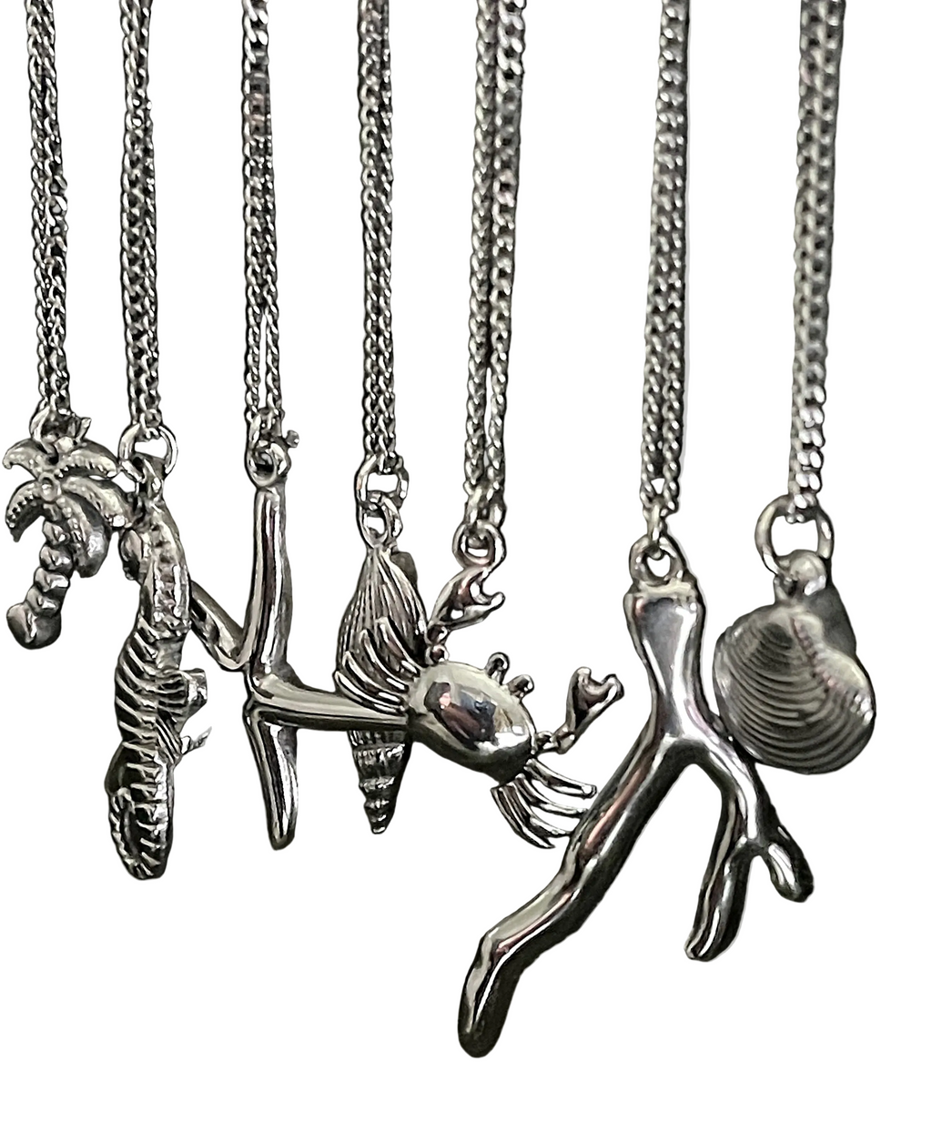 Collection of silver pendant necklaces on a white background