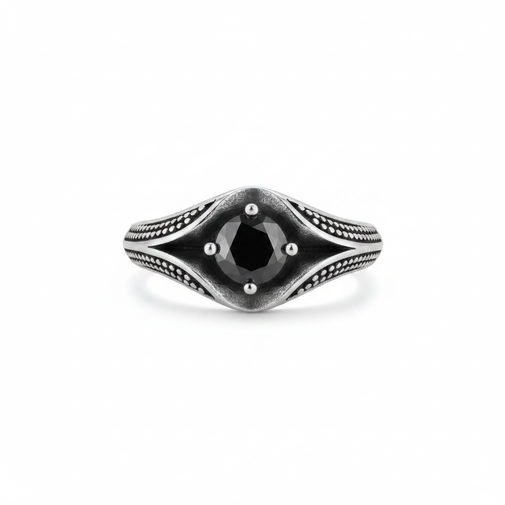 Silver ring with a black cu zirconia gemstone wth dot detailing on a white background.