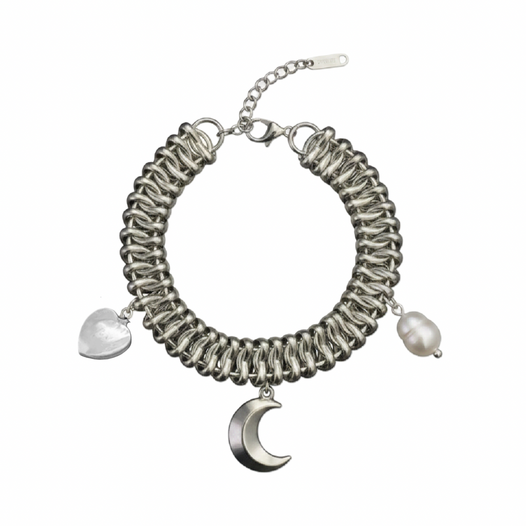 Silver bracelet with pearl and moon charm on a white background