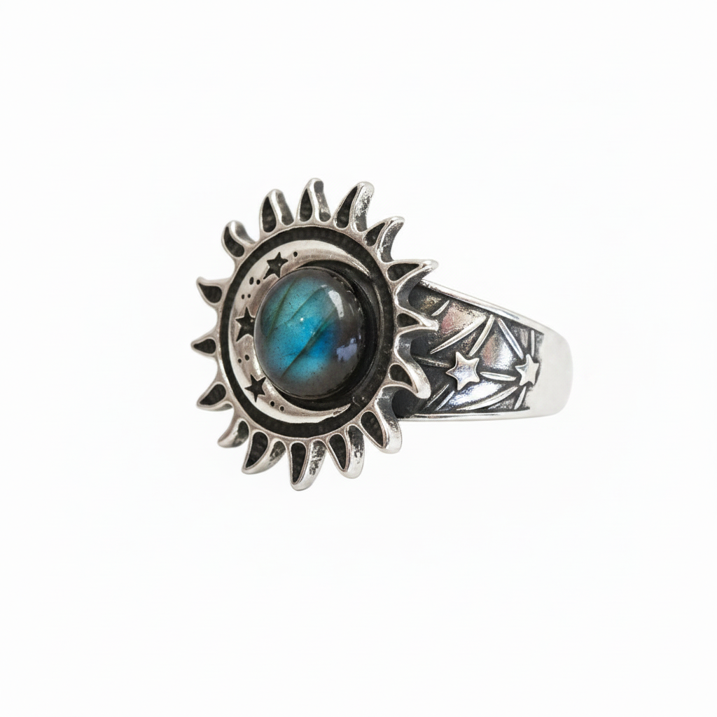 A silver ring with sun, moon and star design with a Labradorite gemstone against a white background.