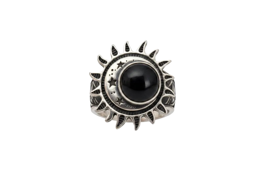 A silver ring featuring a central black round stone surrounded by a sunburst and crescent moon design, set against a plain white background.