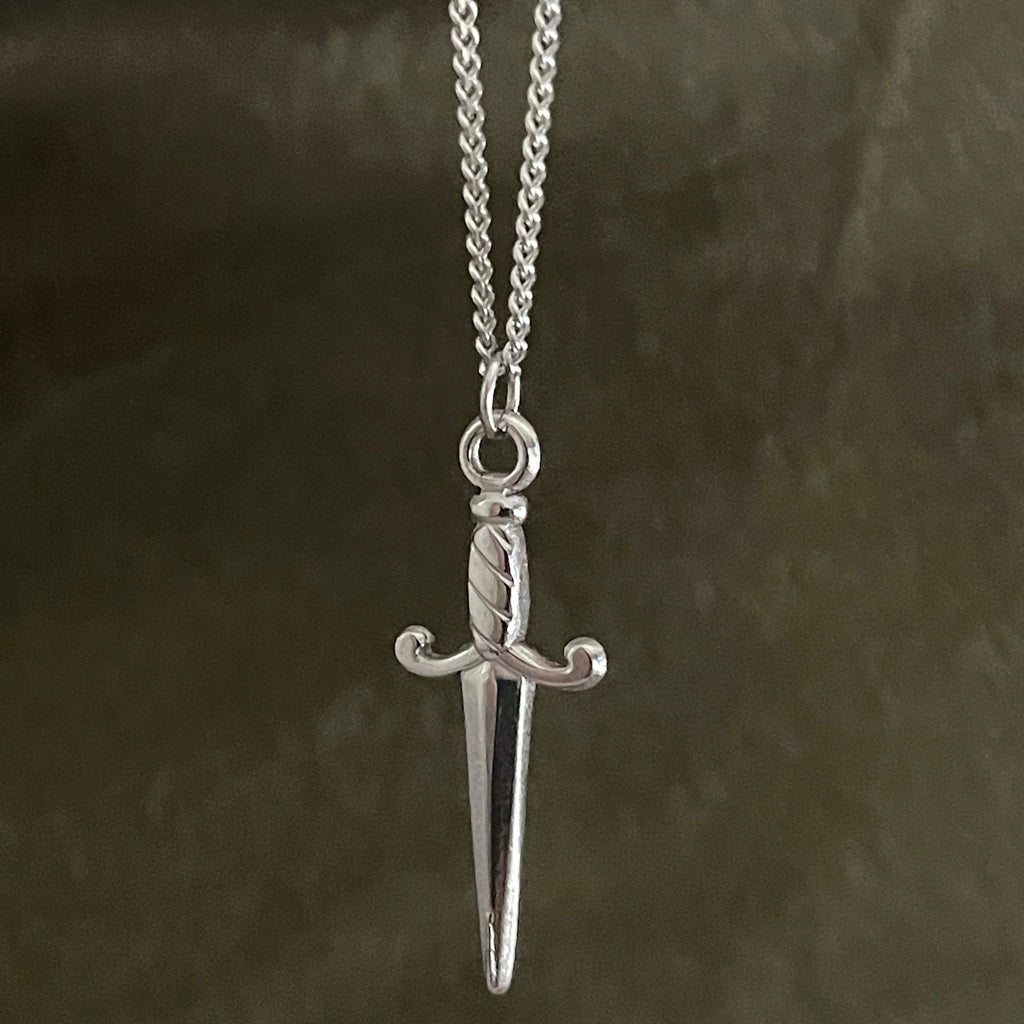 Silver sword pendant necklace on a dark background