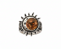 Silver ring with sun, moon and star detail with a round amber gemstone on a white background. 